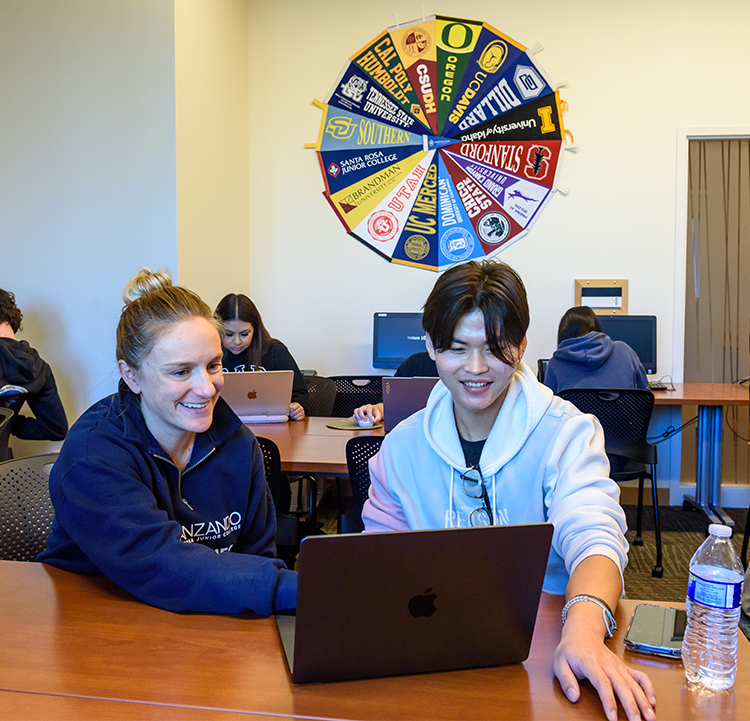 Two transfer students using mac laptop