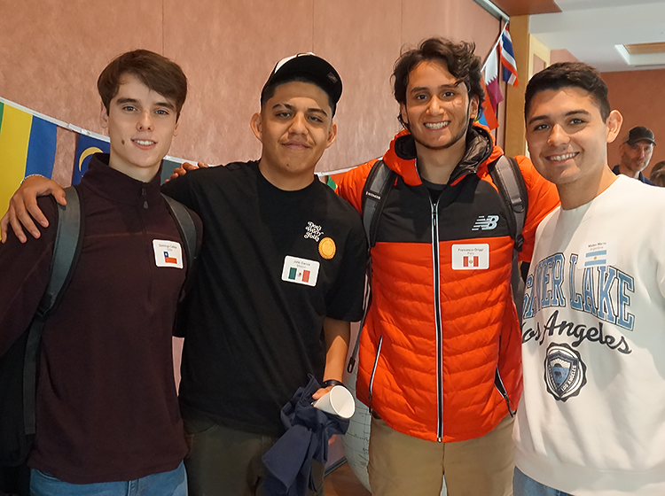 Four Latinx students in the International Student Program at SRJC are smiling at the camera and holding each other’s shoulders in a friendly manner. 