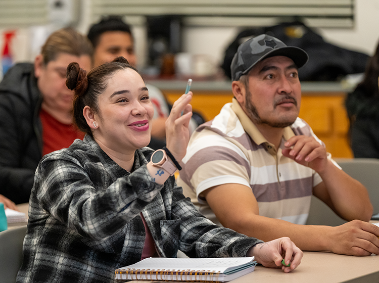 Two students, a white female and Latinx male, are interacting in an English for Multilingual Students classroom at SRJC Roseland. 