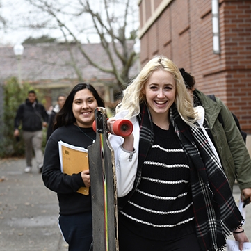 Happy student with a skateboard